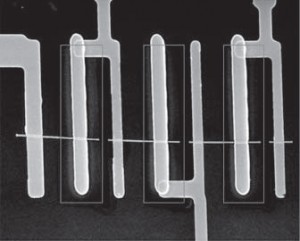 This scanning electron microscopy image shows three solar cells in series on a single nanowire with the core–shell regions marked by brown lines. (Image courtesy of Yang, et. al)