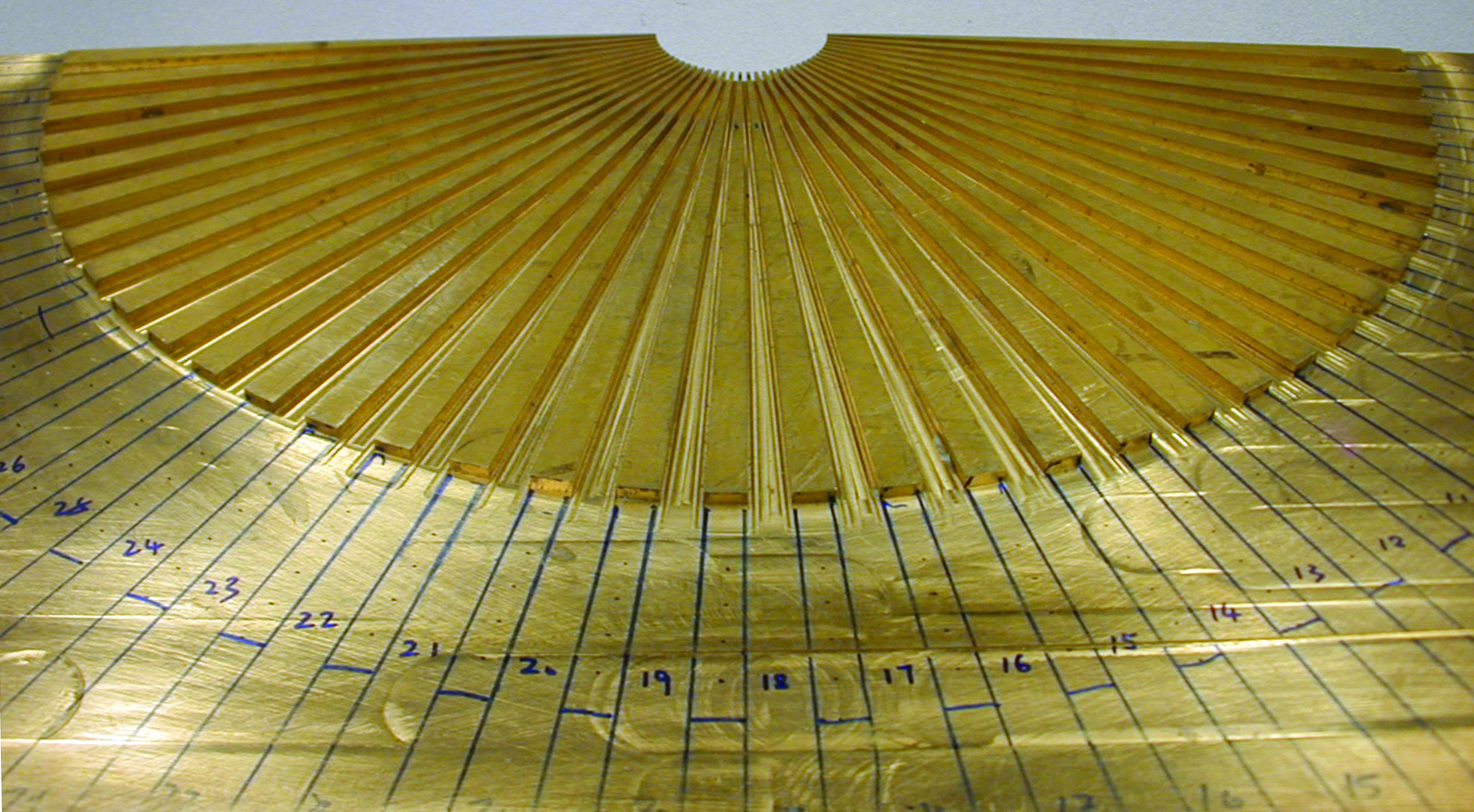 The acoustic hyperlens is fashioned from 36 brass fins arranged in the shape of a hand-held fan. Each fin is approximately 20 centimeters long and three millimeters thick. (Courtesy of Xiang Zhang research group)
