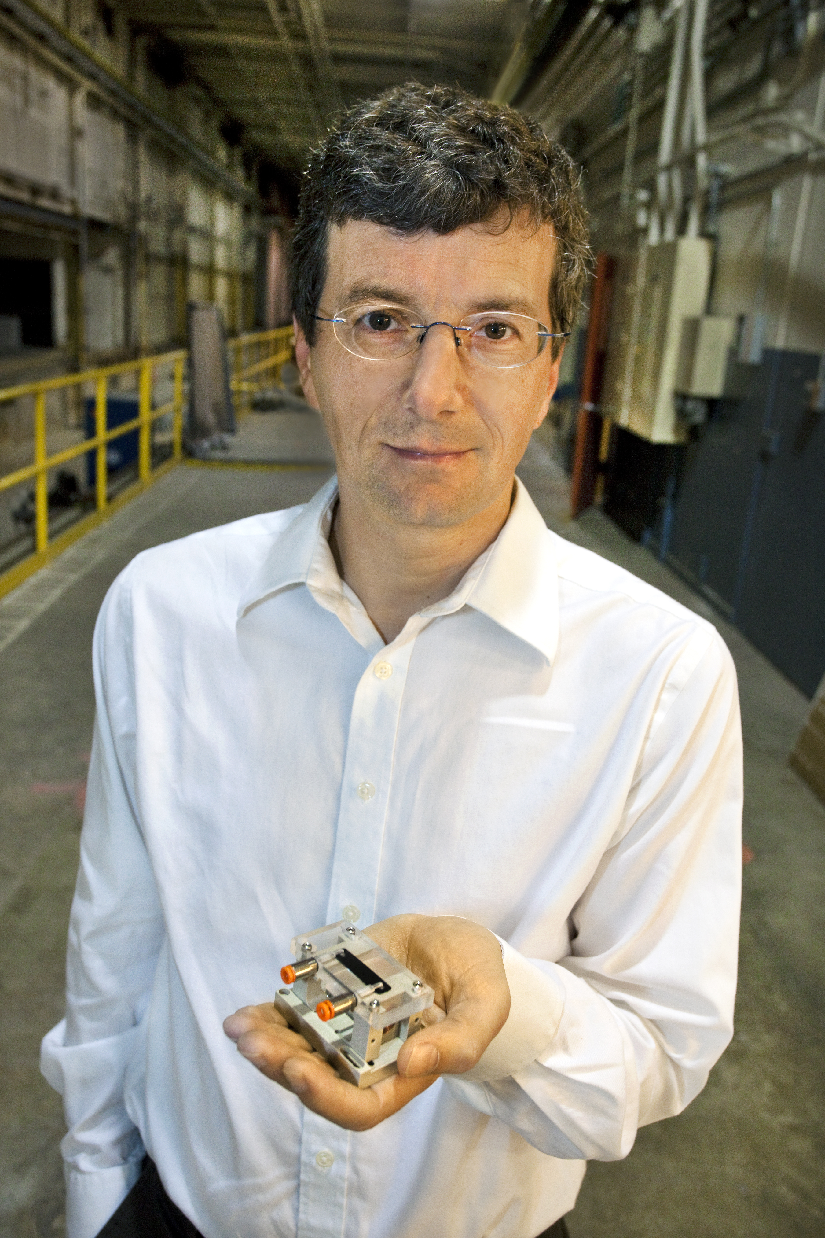 Berkeley Lab's Wim Leemans, winner of the 2009 E. O. Lawrence Award, holds the sapphire accelerator module that the LOASIS team used to accelerate a beam of electrons to one billion electron volts in 3.3 centimeters. 