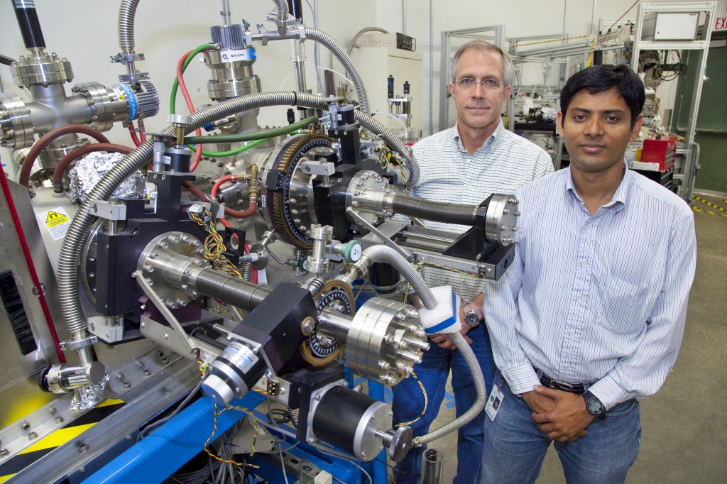 Fundamental research conducted at facilities like Berkeley Lab's Advanced Light Source could enable new energy-saving technologies, such as a magnetic fridge. Sujoy Roy (left) and Jeff Kortright at a scattering chamber at the Advanced Light Source. They're using this tool and the Advanced Light Source's beamline 4.0.2 to learn more about the magnetocaloric effect in alloys. (Image by Roy Kaltschmidt, Berkeley Lab Public Affairs)