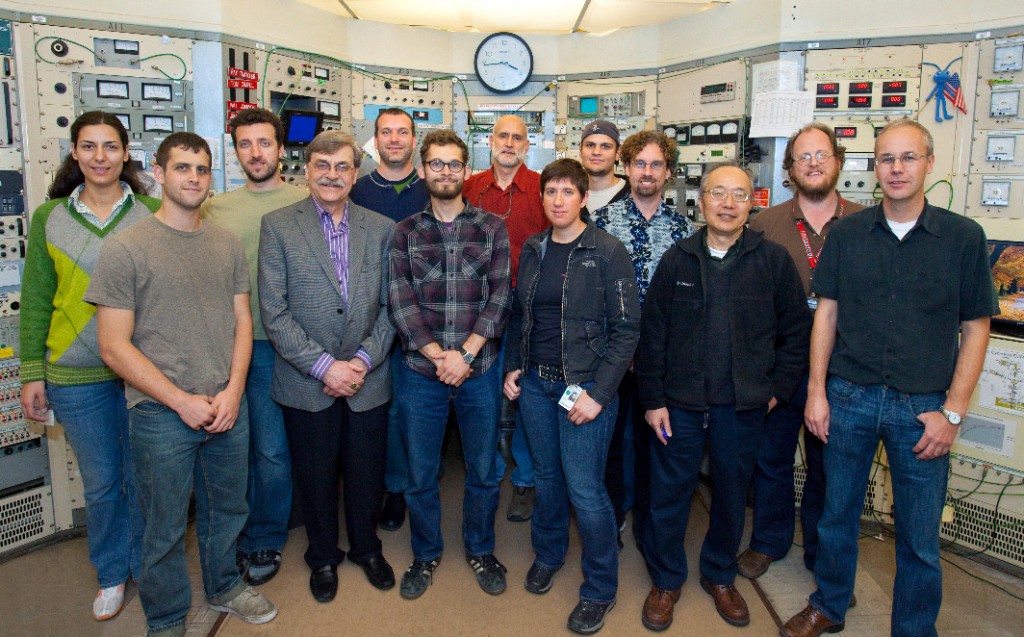 Members of the group that discovered six new isotopes of the superheavy elements in the control room of the 88-Inch Cyclotron, from left: Marina-Kalliopi Petri, Joseph McLaughlin, Stefanos Paschalis, Heino Nitsche, Mathis Wiedeking, Paul Ellison, Kenneth Gregorich, Jacklyn Gates, Oliver Gothe, Darren Bleuel, I-Yang Lee, Roderick Clark, and Paul Fallon. Not pictures are Jill Berryman, Irena Dragojević, Jan Dvorak,  Carolina Fineman-Sotomayor, Walter Loveland, Ji Qian, and Liv Stavsetra. (Photo by Roy Kaltschmidt, Berkeley Lab Public Affairs. Click on image for best resolution.) 