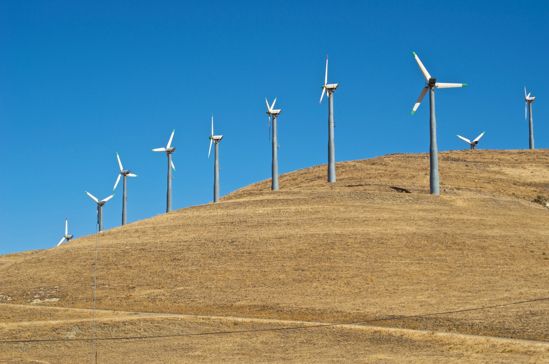 Wind turbines along a hill