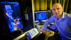 Berkeley Lab biophysicist Sylvain Costes is generating 3D time lapse of DNA repair centers in human cells to understand better how cancer may arise from DNA damage. (Photo by Roy Kaltschmidt, Berkeley Lab)