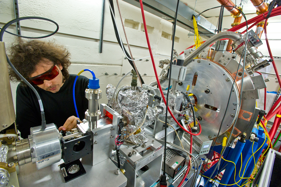 Daniele Filippetto, responsible for APEX's photocathode laser and beam diagnostics, adjusts the mirror that directs the laser to fire into the gun, parallel to the emerging electron beam, to stimulate electron emission from the photocathode. (Lawrence Berkeley National Laboratory photo by Roy Kaltschmidt) 