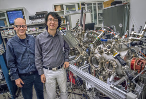 Andreas Schmid and Gong Chen at the SPLEEM instrument in the Molecular Foundry’s electron microscopy center where they are conducting research on magnetic domain walls. (Photo by Roy Kaltschmidt)