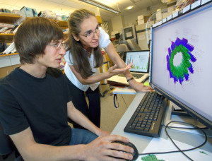 Gregory Alushin and Eva Nogales studying images of microtubule structures. (Photo by Roy Kaltschmidt)