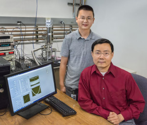 Junqiao Wu (seated) and Yang Fan showed that the flow of heat in black phosphorous nanoribbons can be very different along different directions in the crystal plane. (Photo by Roy Kaltschmidt)