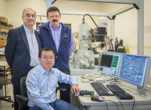 Tony Tomsia (left), Hao Bai (seated) and Rob Ritchie led the development of a bidirectional freezing technique that induces ceramic particles to assemble into scaffolds with centimeter-scale aligned, porous lamellar structures. (Photo by Roy Kaltschmidt) 