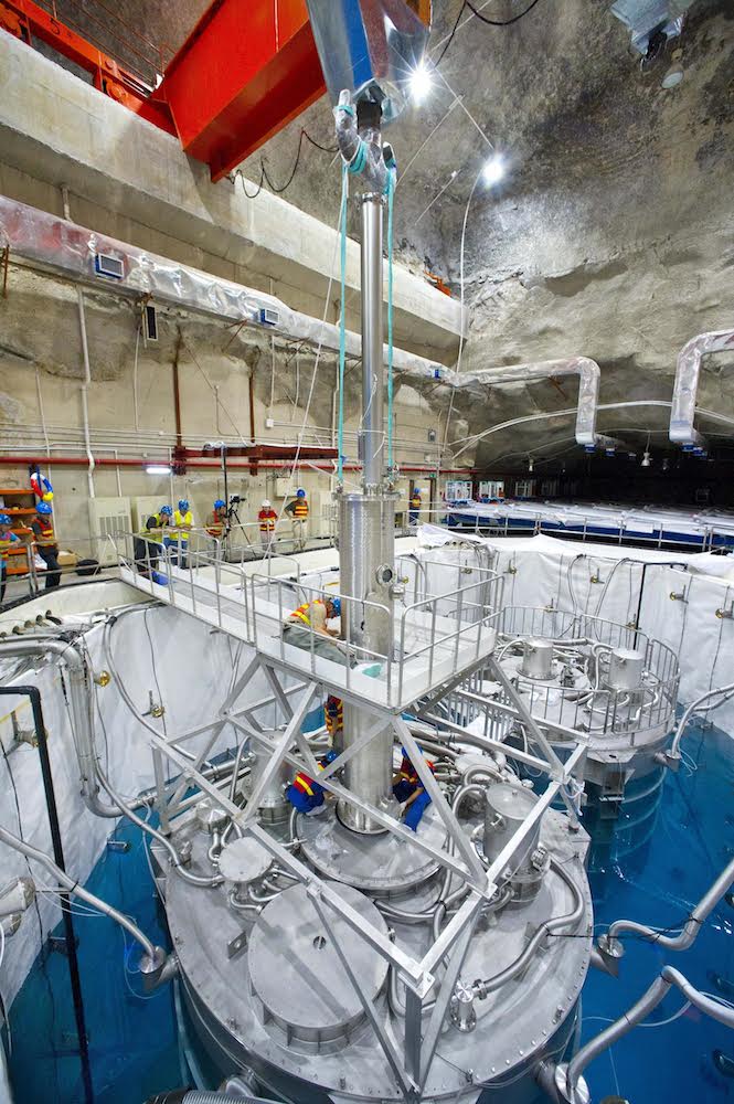 Workers install a Manual Calibration Unit on an antineutrino detector at Daya Bay. This unit was integral in precisely measuring antineutrino energies, as detailed in a new study. (Photo credit: Roy Kaltschmidt)