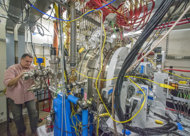 Photo - Berkeley Lab’s Fernando Sannibale inspects the APEX (Advanced Photoinjector Experiment) that has served as a test electron gun and injector system for LCLS-II. (Credit: Roy Kaltschmidt/Berkeley Lab)