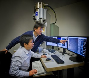 Photo - Gang Ren (standing) and Lei Zhang participated in a study at Berkeley Lab’s Molecular Foundry that produced 3-D reproductions of individual samples of double-helix DNA segments attached to gold nanoparticles. (Photo by Roy Kaltschmidt/Berkeley Lab)