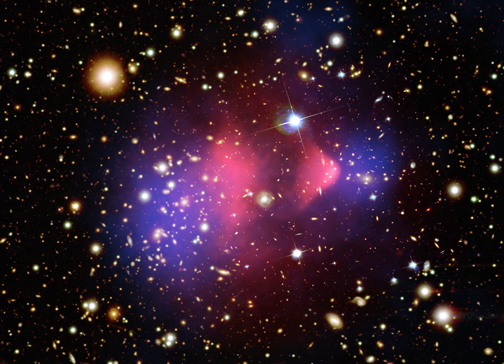 Image - A composite image of the "bullet cluster," a galaxy cluster formed by a collision of two clusters. The pink clumps show hot gas containing most of the normal matter, while the two blue clumps reveal where most of the mass in the clusters is actually contained. This provides evidence for dark matter since most of the mass was expected to be concentrated around the pink areas. (Credit: X-ray image by NASA/CXC/M.Markevitch et al.; optical image by NASA/STScI, Magellan/U.Arizona/D.Clowe et al.; lensing map image by NASA/STScI, ESO WFI, Magellan/U.Arizona/D.Clowe et al.)