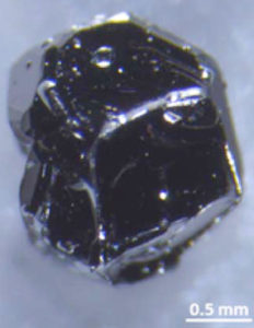 Photo - A single crystal of cadmium arsenide. Single crystals of this material, known as a “Dirac semimetal,” were cut to form nanoscale slices. The slices, when exposed to a magnetic field, exhibited an odd, roundabout electron path. The material could help scientists unlock the secrets of a class of materials that could be used in next-generation electronics. (Credit: Nature, 10.1038/nature18276)