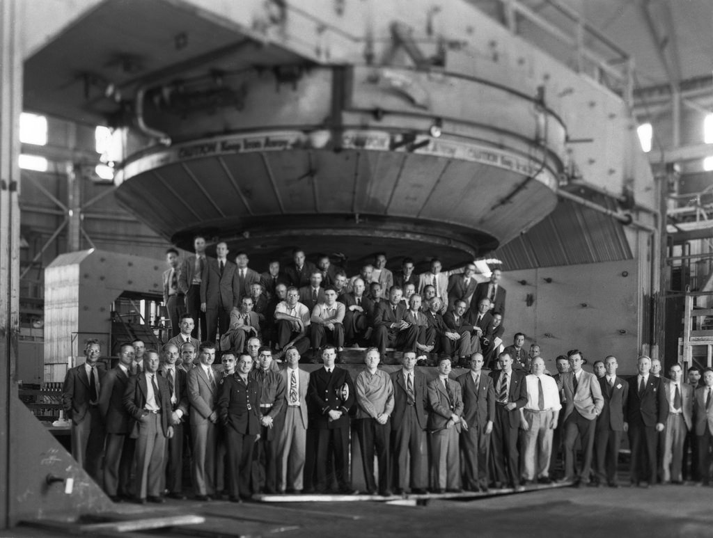 Photo - Ernest O. Lawrence and staff posed with the large magnet at the 184-inch synchrocyclotron, completed in 1946. Berkeley Lab’s Advanced Light Source is now located in the building that housed the synchrocyclotron. (Credit: Berkeley Lab)
