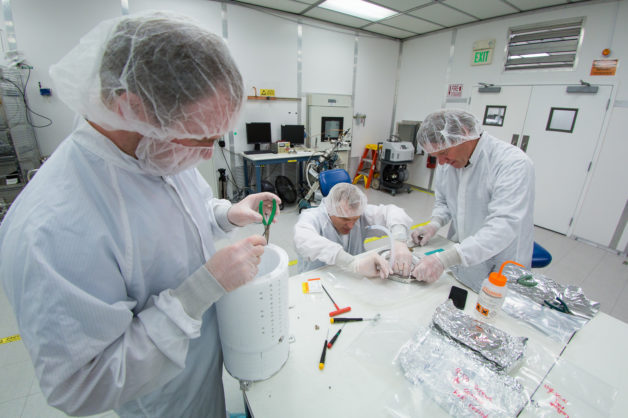 Photo - Assembly of the prototype for the LZ detector’s core, known as a time projection chamber (TPC). From left: Jeremy Mock (State University of New York/Berkeley Lab), Knut Skarpaas, and Robert Conley. (Credit: SLAC National Accelerator Laboratory)
