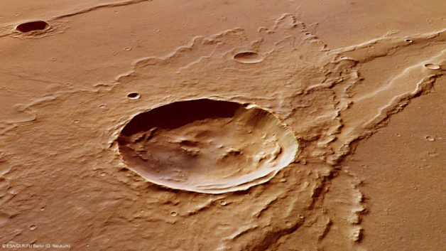 Image - This example of an impact crater on Mars, named Melas Dorsa, shows a rich geological history. The image was created by the European Space Agency's Mars Express. Studies of simulated martian meteorite minerals suggest that Mars may have been more water-rich than previously thought. (Credit: G. Neukum/ESA,DLR, FU Berlin)