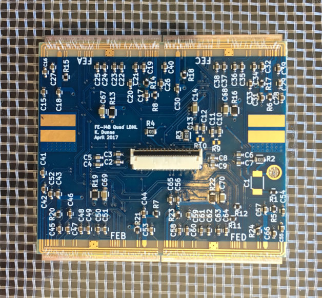 Photo - A quad module with a printed circuit board (PCB) for power and data interface to four FE-I4B chips. Dunne designed the PCB. (Credit: Katie Dunne/Berkeley Lab)