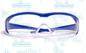 Image - Scientists have developed a faster chemical process for making a class of sulfur-containing plastics. The technique could make these plastics more competitive with polycarbonates, which are strong plastics used to make safety goggles like the ones shown here, among other products. Chemical diagrams relevant to the new technique are displayed in the background. (Credits: Wikimedia Commons, Berkeley Lab)