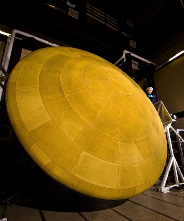 Photo - The Mars Science Laboratory, which landed the Curiosity rover on MARS, featured the largest heat shield (the underside is shown here)—at 14 feet 9 inches in diameter—to enter a planet’s atmosphere. NASA is now engaging in R&D for even larger heat shields made of flexible, foldable material that can open up like an umbrella to protect spacecraft during atmospheric entry. (Credit: NASA/JPL-Caltech/Lockheed Martin)