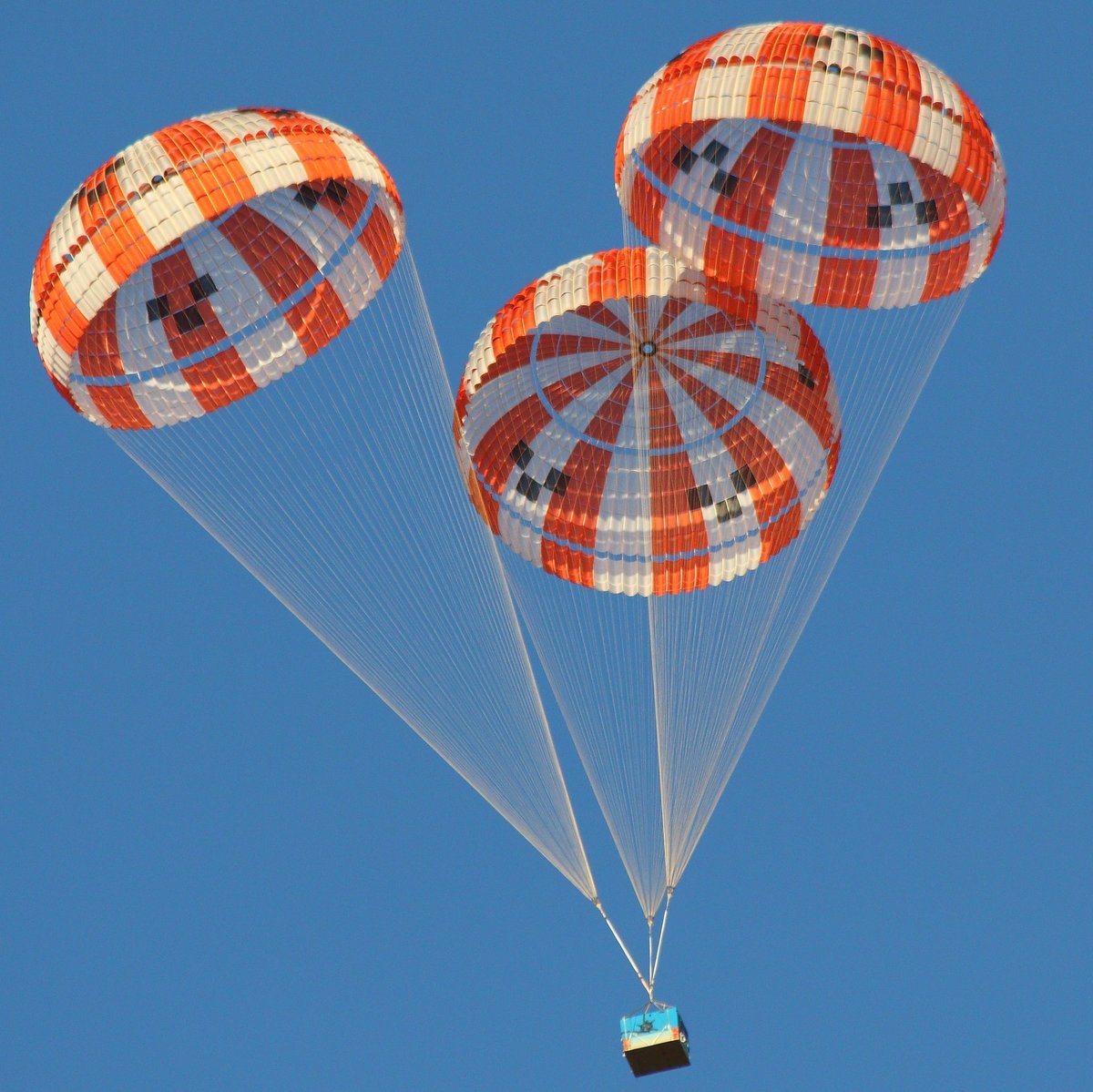 Photo - This array of parachutes, designed for NASA’s Orion spacecraft, is seen here during a test above Eloy, Ariz., in 2015. Several parachute designs for Orion have also been tested in NASA wind tunnels. (Credit: NASA)