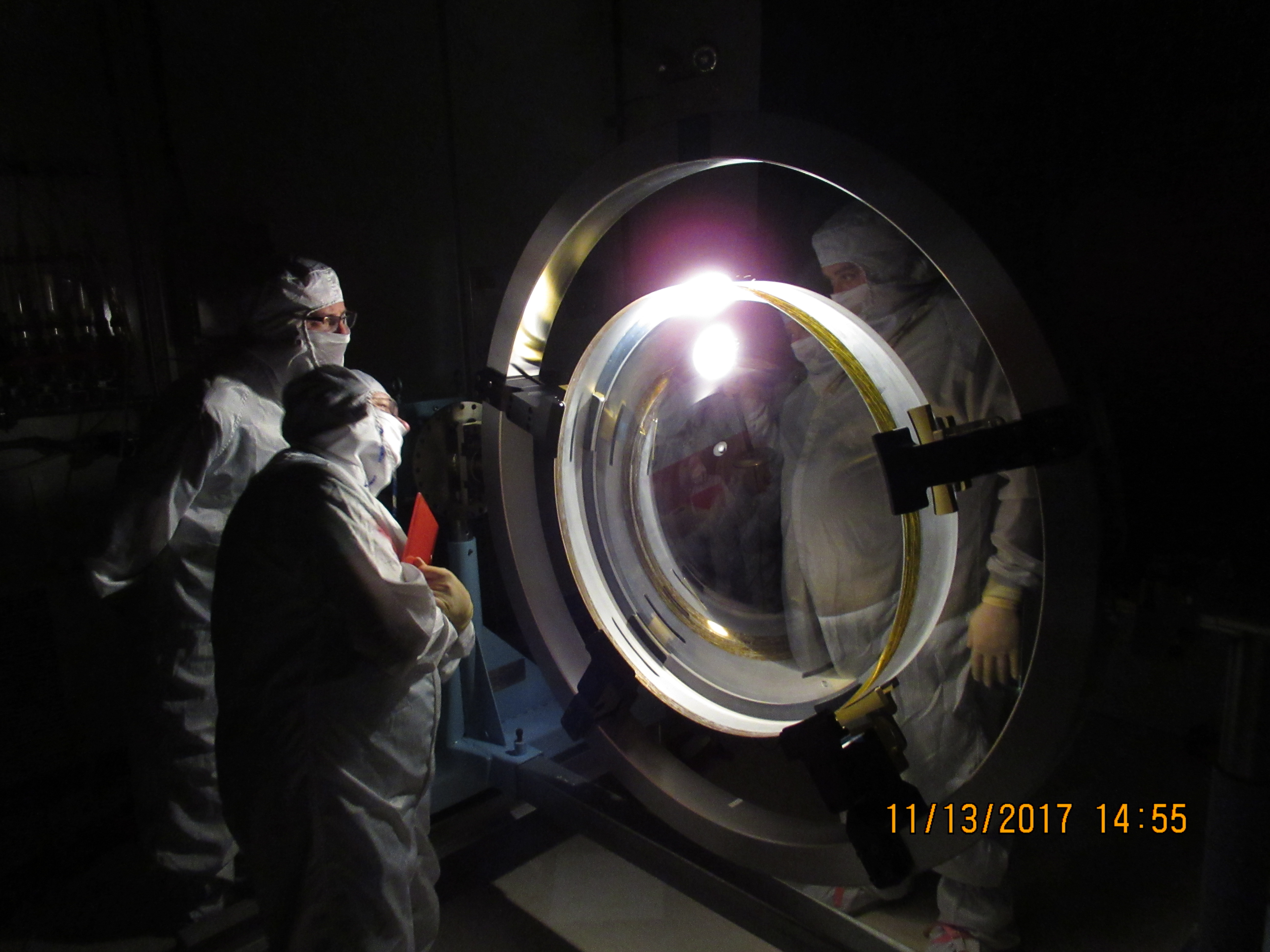 Photo - The lens is inspected for scratches after a coating is applied. The inspection is conducted by illuminating the lens with a bright light in a darkened room.