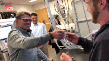 Animated GIF: Energy Secretary Rick Perry, left, and Berkeley Lab’s Raymond Weitekamp struggle to break a 3-D-printed wishbone made of a rugged COR Alpha polymer material at Berkeley Lab’s Molecular Foundry. (Credit: Kelly J. Owen/Berkeley Lab) 