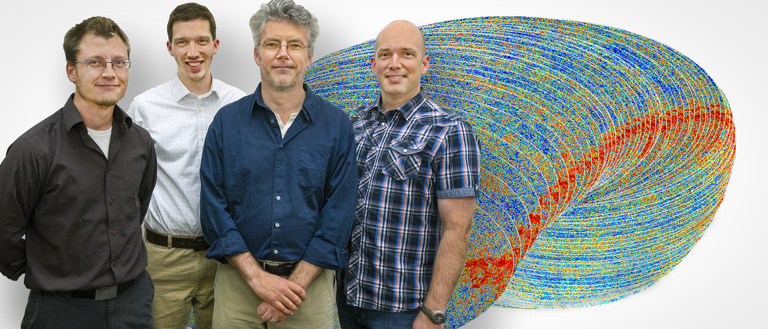 Photo - The Planck analysis group with CMB Planck data images. From left to right: Reijo Keskitalo, Aaron Collier, Julian Borrill and Ted Kisner. (Credit: Roy Kaltschmidt/Berkeley Lab)