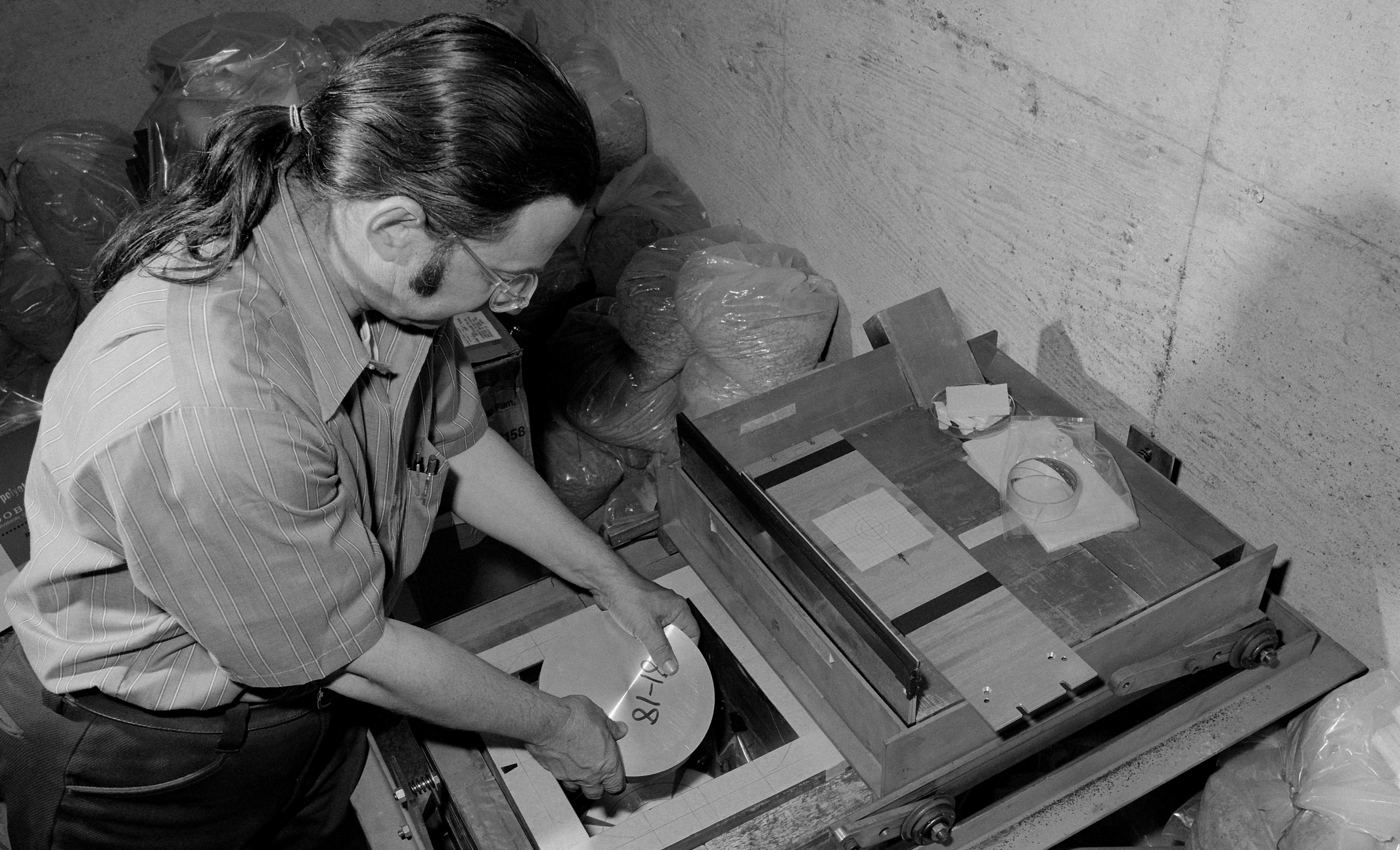 Photo - Alan “Al” Smith places an aluminum sample exposed to radiation at Berkeley Lab’s Bevatron accelerator into a lead and concrete box containing a detector at a low-level radiation counting facility in this 1950s photograph. (Credit: Berkeley Lab)