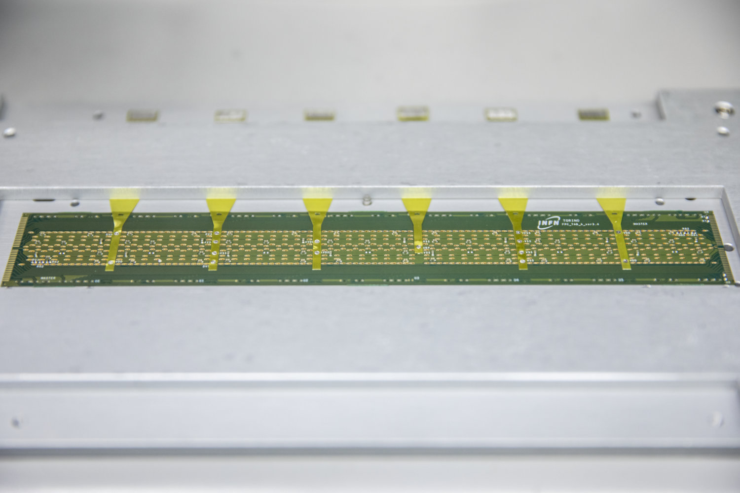 Photo - These silicon chip components are prepared for placement on a detector stave. (Credit: Marilyn Chung/Berkeley Lab)