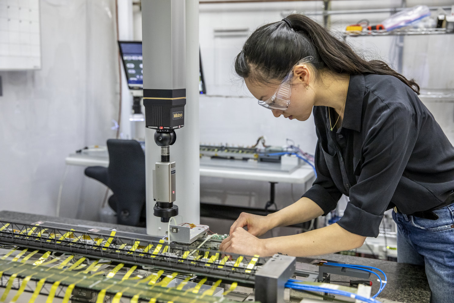 Photo - Berkeley Lab’s Erica Zhang conducts measurements of a detector stave during assembly. (Credit: Marilyn Chung/Berkeley Lab)