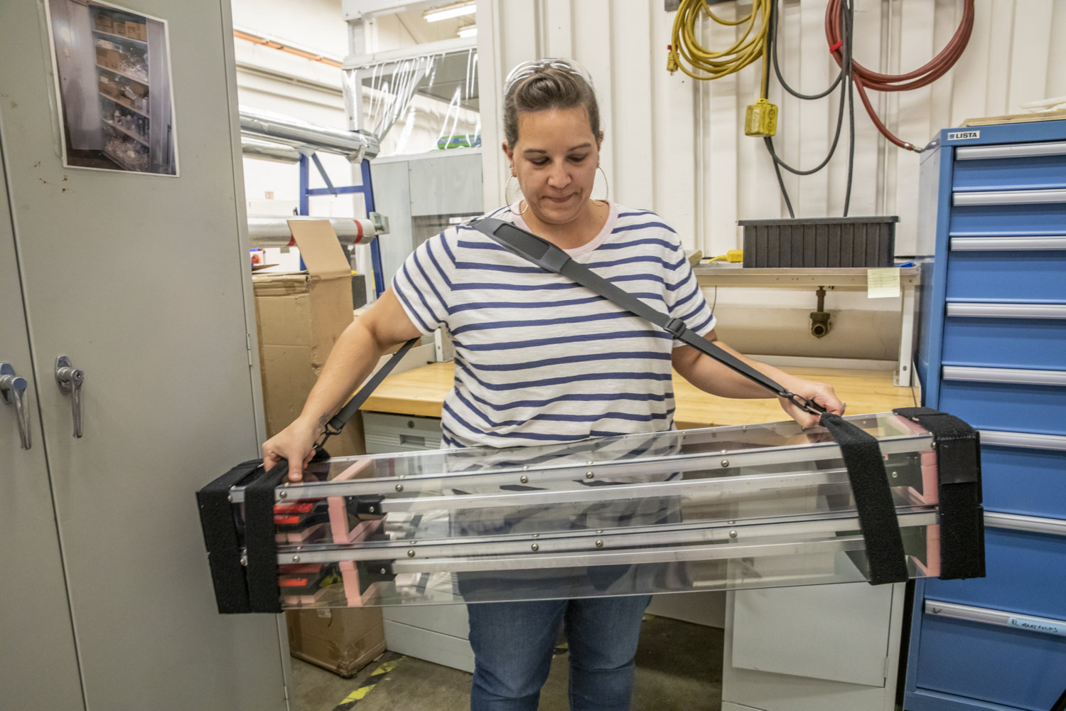 Photo - Nicole Apadula holds a custom-built carrying case designed for four detector staves. The case is hand-carried aboard commercial flights to ensure safe transport of the detector components to CERN laboratory in Europe. (Credit: Marilyn Chung/Berkeley Lab)
