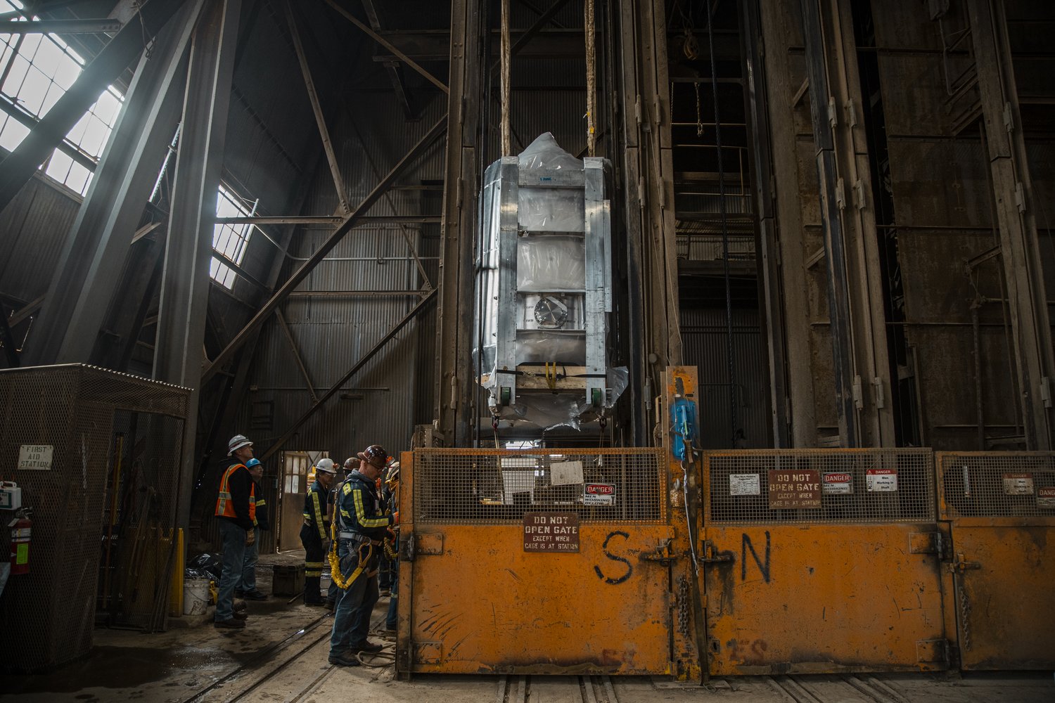 Photo - Crews at the Sanford Underground Research Laboratory in Lead, South Dakota, begin to lower the LUX-ZEPLIN central detector down nearly mile-long descent down an elevator shaft. The move was successfully completed last week. (Credit: Nick Hubbard/Sanford Underground Research Facility)