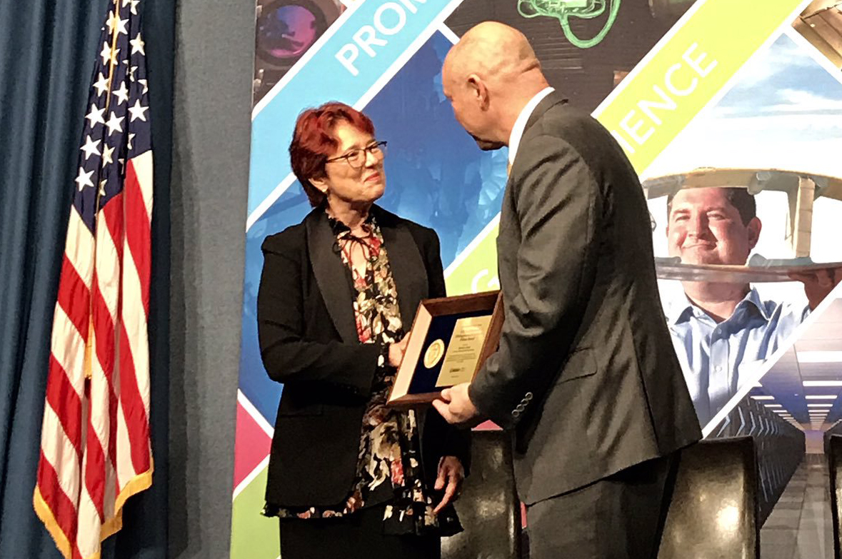 Photo - Berkeley Lab's Barbara Jacak receives her award from Chris Fall, director of the Department of Energy's Office of Science, in an Oct. 16 ceremony. (Credit: U.S. DOE)