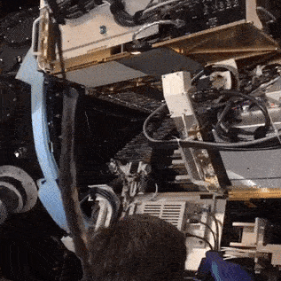 GIF - In this time-lapse video, crews use a special machine to install an individual wedge-shaped pedal in DESI’s focal plane, which is installed atop the Mayall Telescope at Kitt Peak National Observatory near Tucson, Arizona. The roundish focal plane is made up of 10 pedals, and each pedal holds 500 robotic positioners that individually target galaxies to collect their light via thin fiber-optic cables. (Credit: Christian Soto, National Optical-Infrared Astronomy Research Laboratory/AURA/NSF)