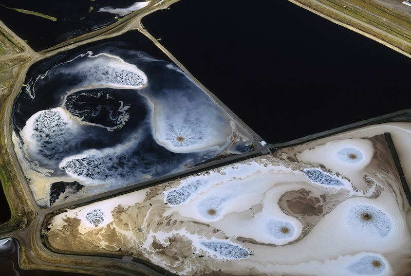 Deep blue, swirling evaporation ponds from above