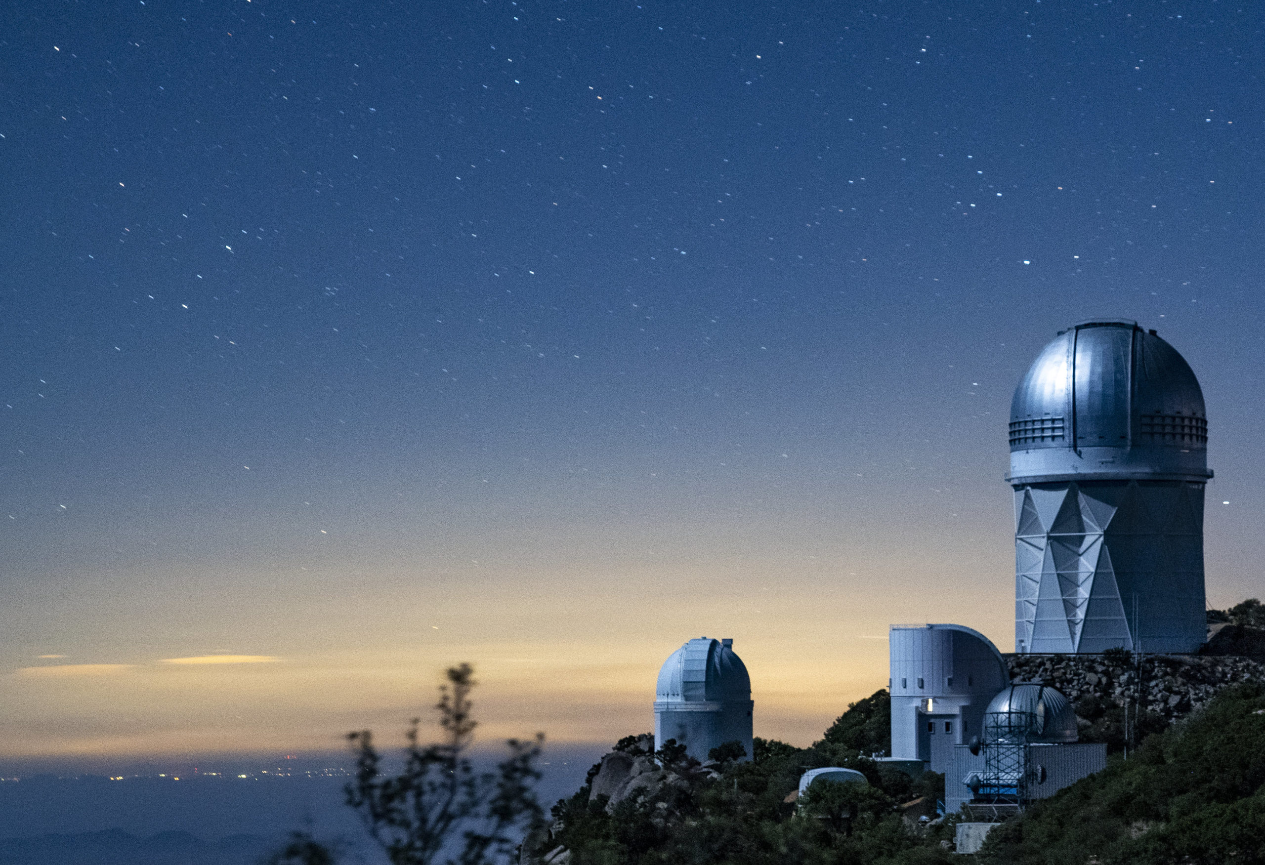 Photo - Kitt Peak National Observatory at dusk. DESI, the Dark Energy Spectroscopic Instrument, is housed within the Mayall Telescope dome (right). (Credit: Marilyn Sargent/Berkeley Lab)