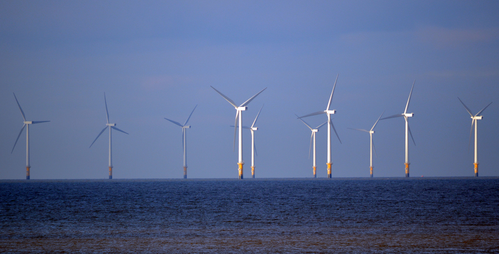 photo of floating wind turbines in the ocean