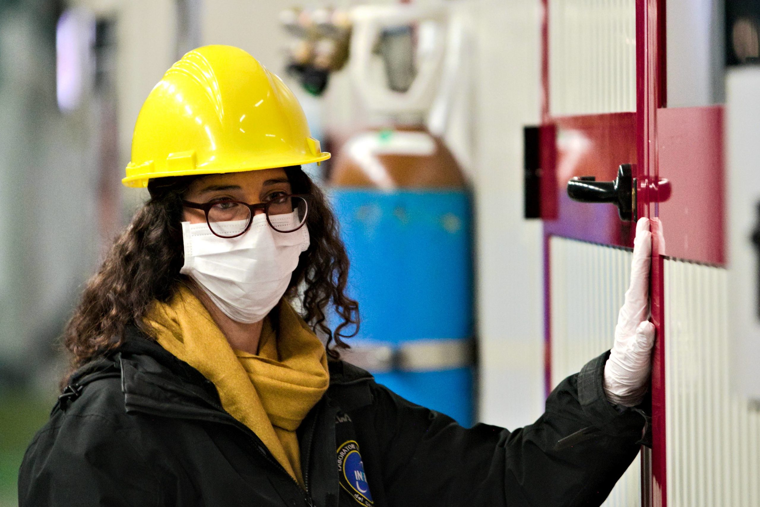 Image - Laura Marini now wears a protective mask and gloves, in addition to a hard hat, during her visits to the CUORE experiment site. (Credit: Gran Sasso National Laboratory – INFN)