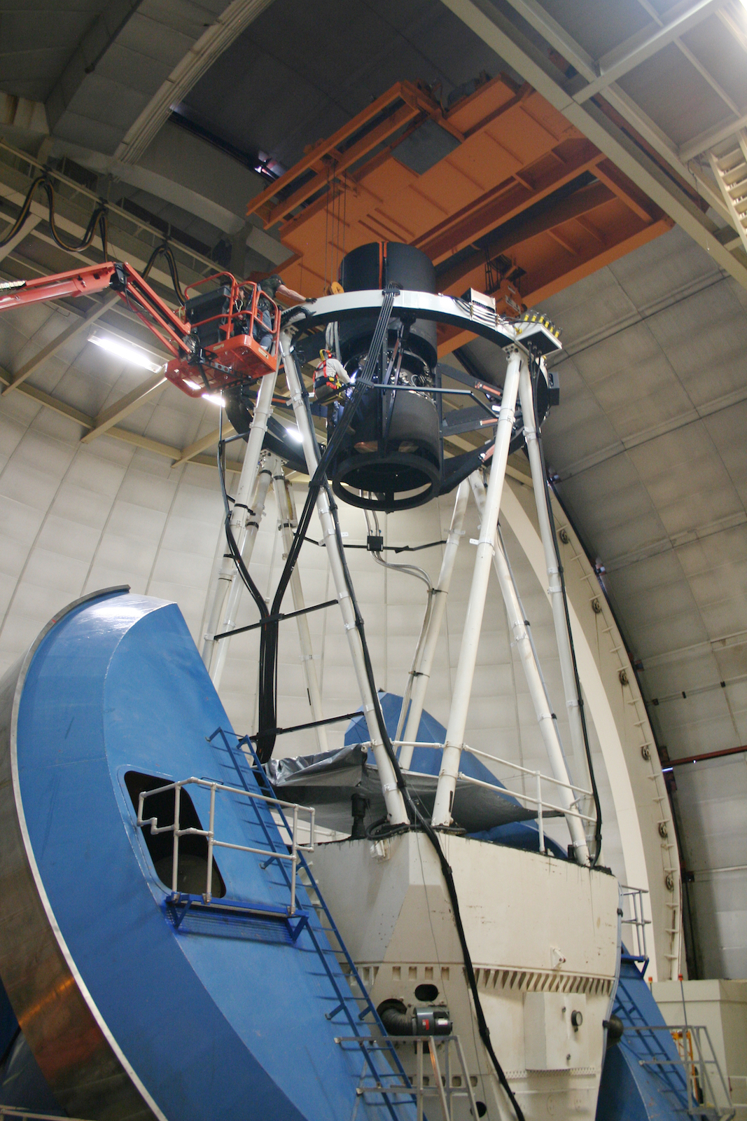 Photo - Workers install a component on DESI, which is mounted on the Mayall Telescope at Kitt Peak National Observatory. (Photo courtesy of Robert Besuner/DESI collaboration)