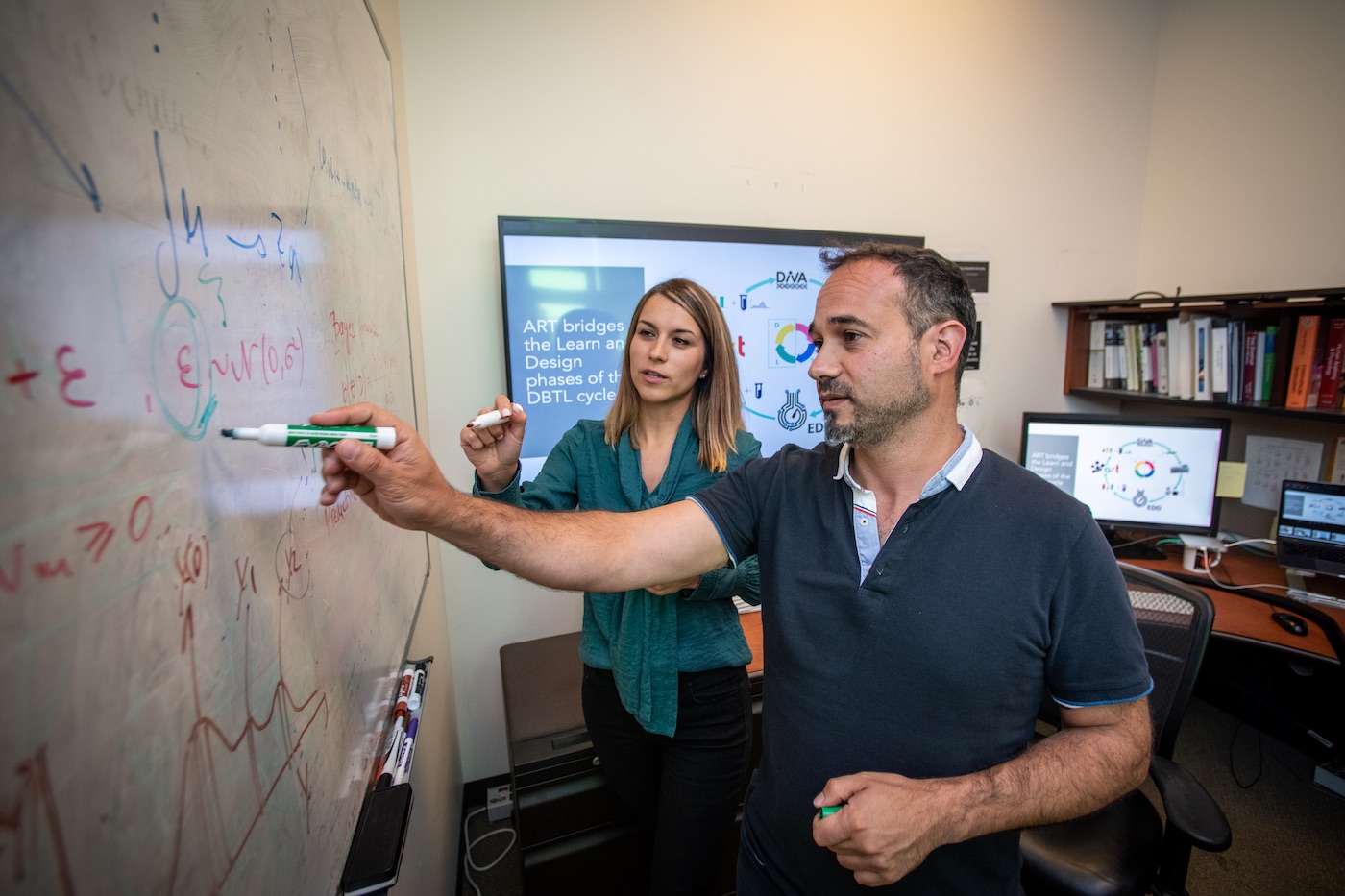 Tijana Radivojevic (left) and Hector Garcia Martin work on mechanical and statistical modeling, data visualizations and metabolic maps at the Agile BioFoundry.