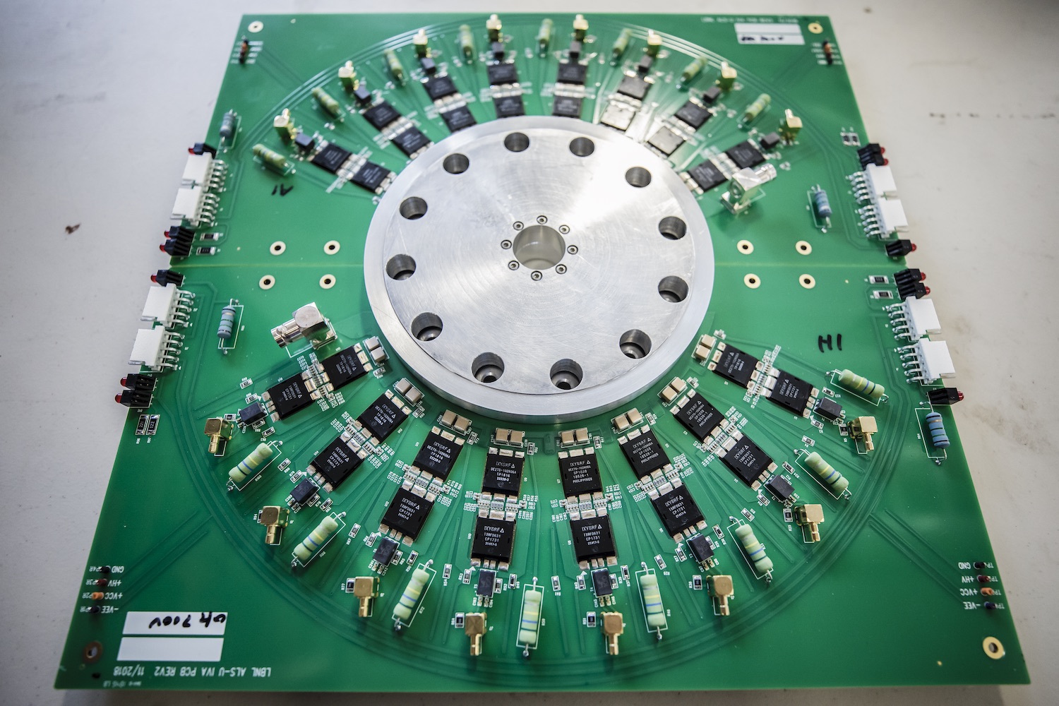Photo - This silicon-based device is one of eight stages of an inductive voltage adder, which is used to drive a "kicker" that kicks electrons from one path to another. (Credit: Marilyn Sargent/Berkeley Lab)