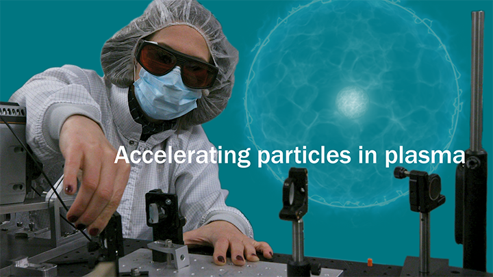 Graphic collage of a person in PPE standing in front of a particle