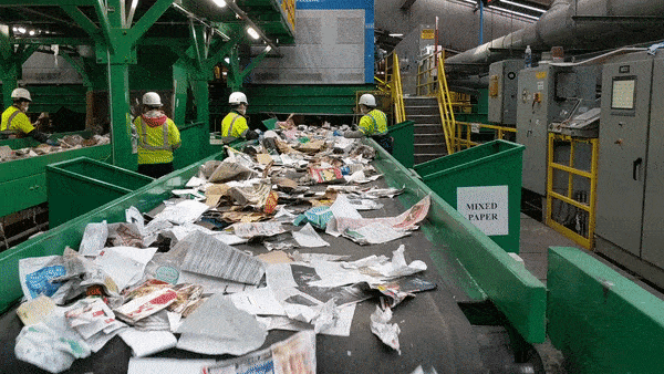 Workers sort recycling at a recycling center
