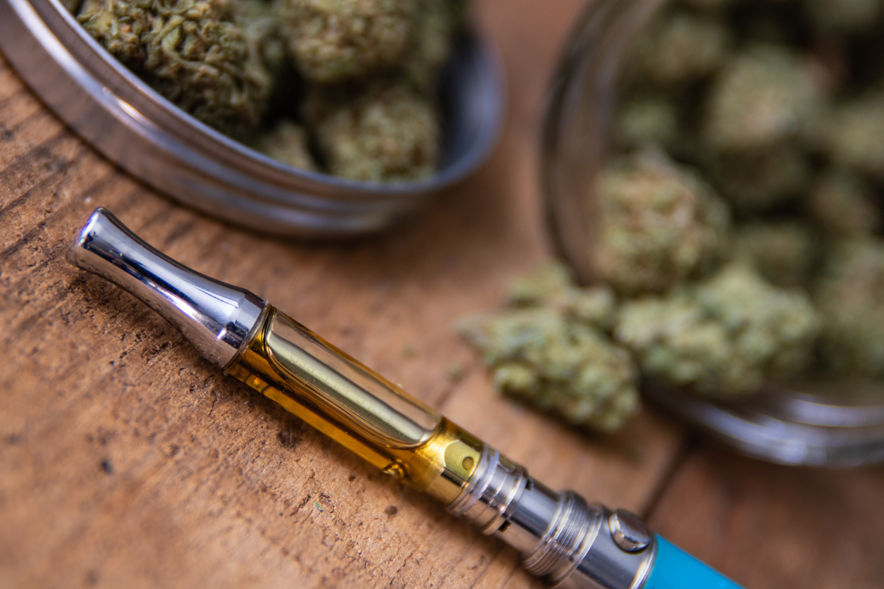 artsy close-up photo of cannabis and vape pen