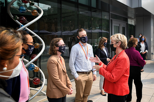 U.S. Secretary of Energy, Jennifer Granholm, speaks with scientists in from the Berkeley Lab's Joint Genome Institute.