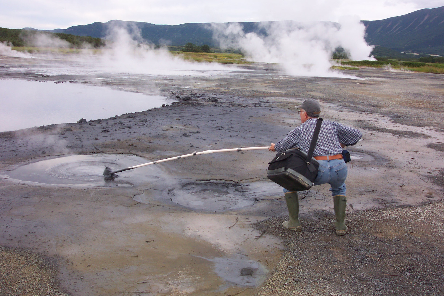 Tamas Torok collecting field samples in the Uzon Caldera, a volcanic environment located on the Kamchatka Peninsula in the Russian Far East, to find extremophiles.