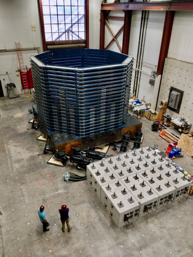 An overhead perspective of a large warehouse holding a soil box seismic activity system.