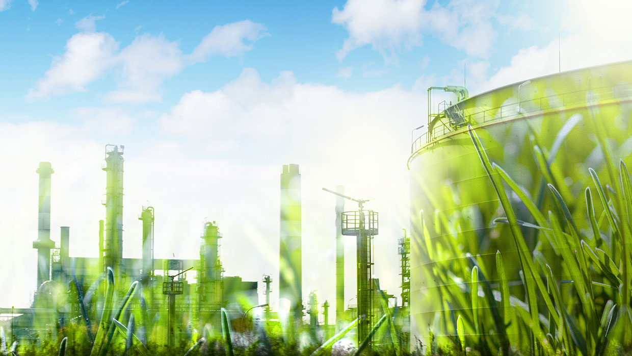 Worms eye view of an industrial development obscured by blades of grass.