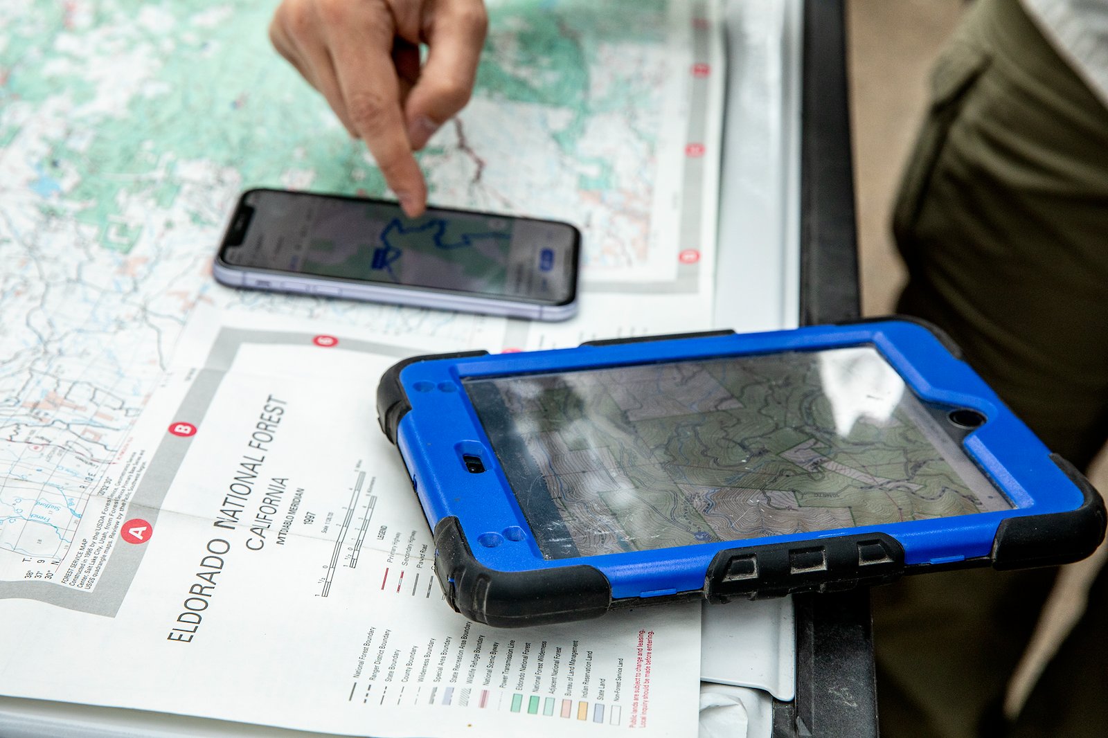 A phone and an ipad sitting on a map
