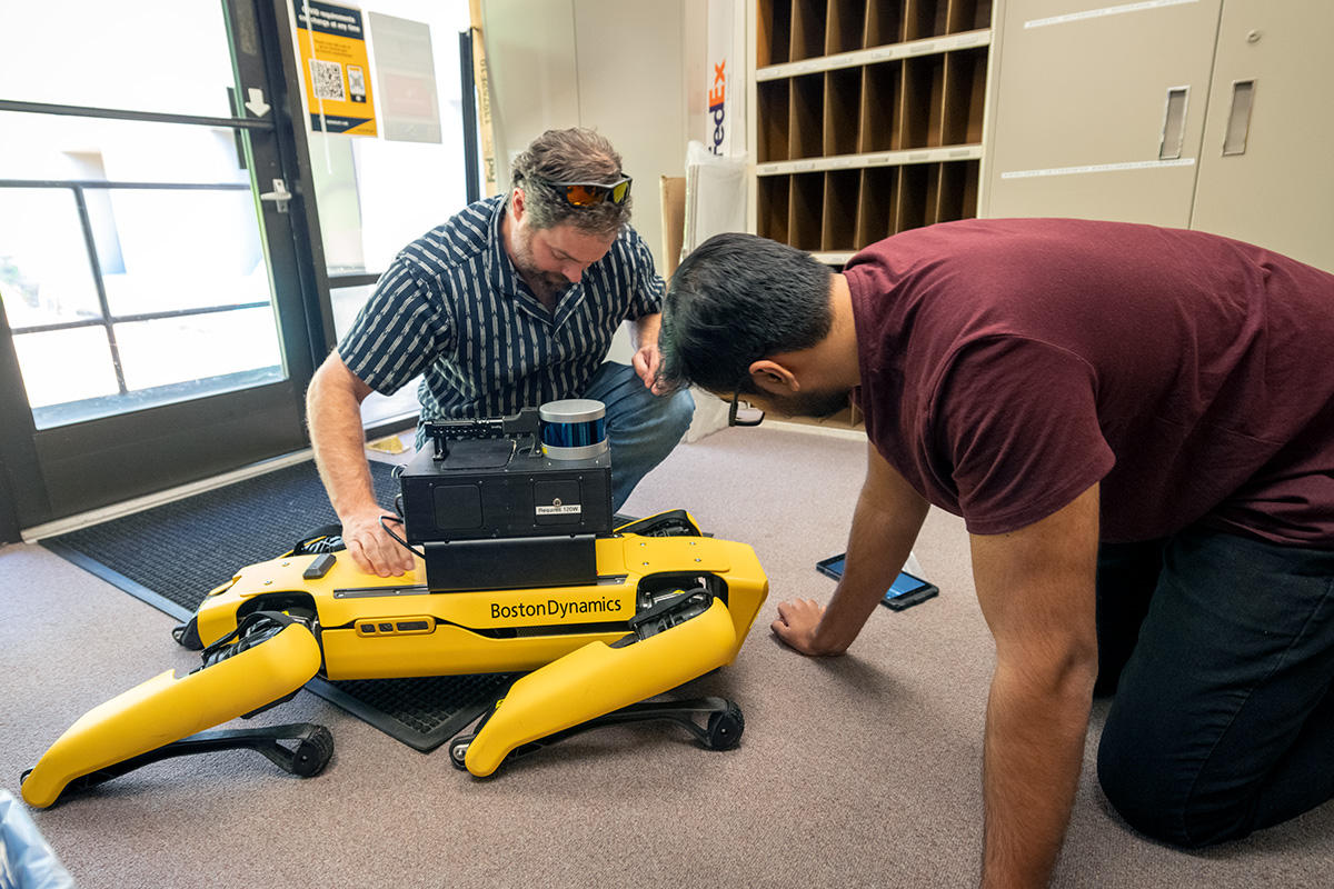Brian Quiter (left) and Kushant Patel test the physical coupling of a radiation imaging system with a Boston Dynamics Spot Robot.